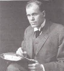 Black-and-white portrait of Dr. Oakley Smith, founder of Naprapathy, seated and holding anatomical materials.